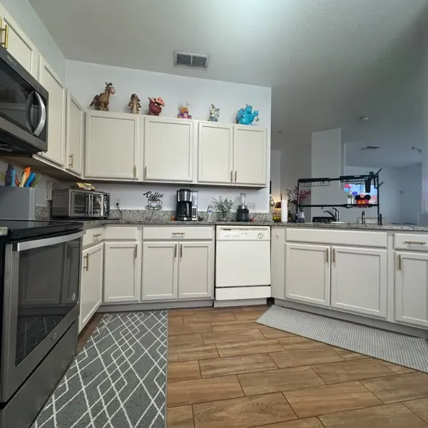 The finished kitchen with cream cabinets, cleaned and ready to use