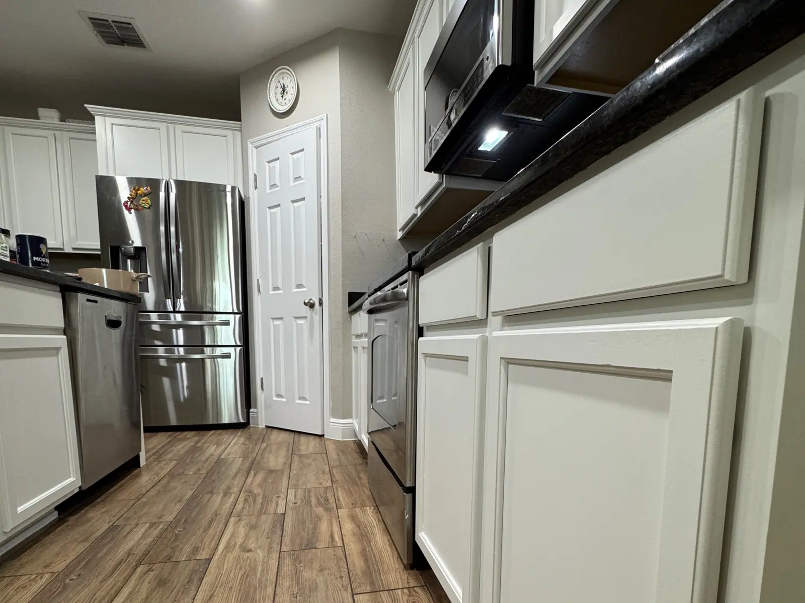 Finished white base cabinets and a clean floor