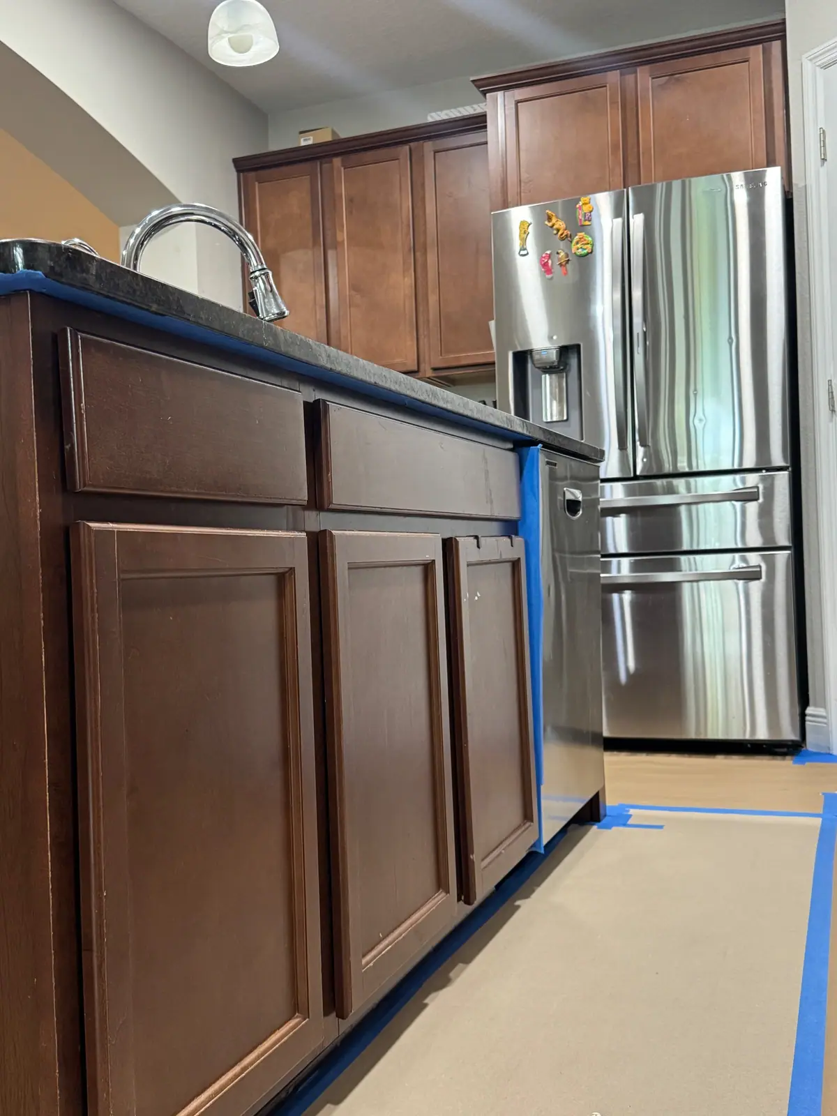 Island corner and fridge edge masked with blue tape