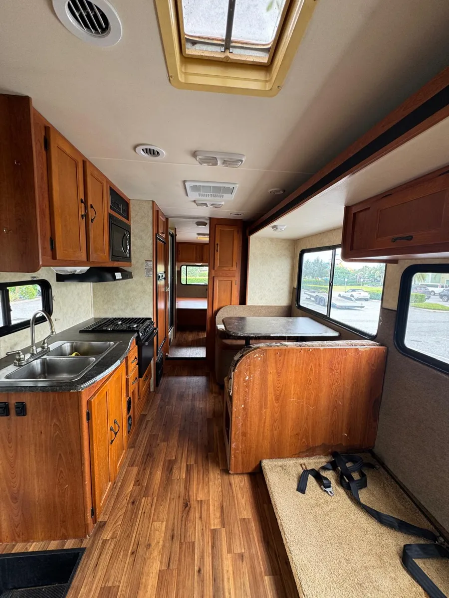 Motorhome kitchen with wood cabinets before painting