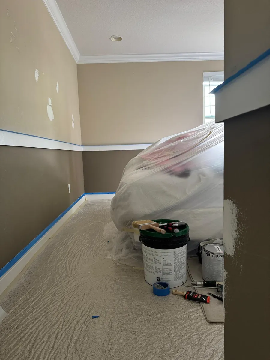 Chair rail taped, floor covered and the bed wrapped in plastic before painting